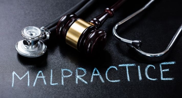 A stock photo for a stethoscope with the word 'Malpractice' written with the frame.